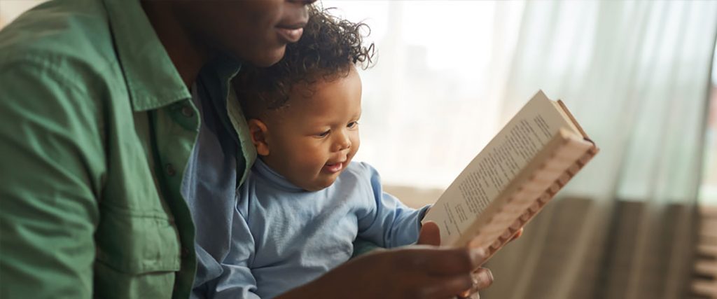 father reading baby a book