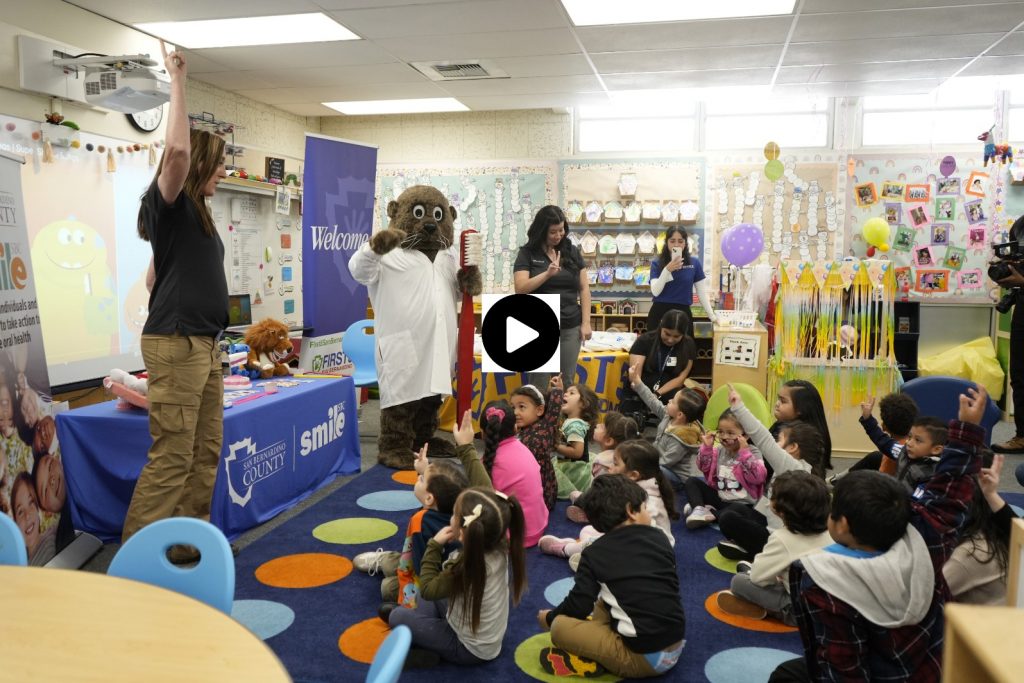 Instructor training kids on brushing teeth